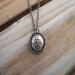Handcrafted sterling silver lotus flower yoga necklace on wooden background, 16"-20" chain, unique gift design.
