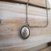 Handcrafted sterling silver lotus flower yoga necklace on wooden background, 16"-20" chain, unique gift design.
