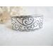 Wide sterling silver cuff bracelet with layered scrollwork pattern. 