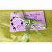 Image of tissue paper wrapping and a bow and a business card for a jewelry order.