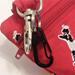 dog poop bag holder and dog training treat pouch black and white poodles on red fabric carabiner detail