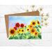 This is a greeting card from a hand painted watercolor of different colored sunflowers of red orange and yellow.