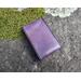 Handmade Premium Leather Tarot Card Case in a purple hue called Violet Cosmos with black hand stitching. Outside in natural light.