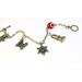 Image is of a Jewish charm bracelet with 4 charms:
Shabbat candles
Star of David
Torah 
Hamsa