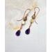 Earrings with yellow opal on wire and deep purple wire wrapped amethyst briolette dangles. On handcrafted copper earring wires.