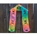 A pic of a multi-color scarf with eggs along its length.