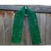 A green scarf with leaves along its length.