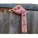 Another pic of a pink scarf with balloons along its length.