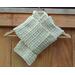 A beige v stitch crochet scarf display.