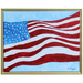 Colorful US Flag Art. This is an abstract flag that appears to be blowing in the wind. The flag is on a blue background and the art has a gold frame.