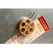 front view of a gold miniature movie reel magnet holding up a movie ticket on fridge