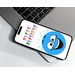 silly blue smiling face with colorful letter characters forming happy birthday above it and blue diamond shaped stars above the head, against a white background, on a cellphone