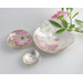 Set of three nesting trinket dishes made from a vintage silverplated brass serving tray. Largest dish is a bird shape, two smaller dishes are round. Photo shows all three side by side, one with tiny rose blossom floating in water.