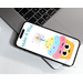 pink blue and yellow icing on a cupcake with large smiling eyes, sparkling candle on top, caption showing make a wish on a cellphone