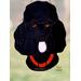 Black poodle in direct sunlight.