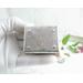 photo shows the bottom of the silver trinket box, close up of tiny protruding feet and my signature, SW
