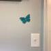 Teal acrylic butterfly on wall