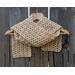Display of the Shell Crochet Scarf pattern on a hanger in front of a wooden fence.