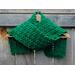 A green shell crochet scarf display.
