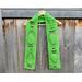 Display of the Balloon Crochet Scarf Pattern on a hanger in front of a wooden fence.