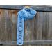 Another pic of a blue scarf with snowmen along its length.