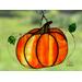 Pumpkin with lampwork leaves in direct sunlight.