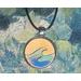Vitage style round wooden necklace made of wood in a silver stainless steel 1" cabochon with black leather necklace. Green and blue waves.