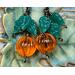 Pumpkin earrings with vintage orange lucite beads glowing in the light