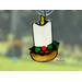 Candle stained glass ornament in direct sunlight.