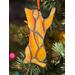 Close up of cat ornament (orange) in Christmas tree.