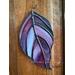 Dogwood stained glass ornament on wall.