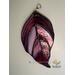 Dogwood stained glass ornament on wall.