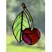 Cherry stained glass ornament in direct sunlight.