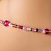 Bead detail, of a glass choker necklace.