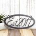 Oval established year metal plaque, in silver vein powder coat.