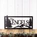 Rectangular personalized metal family name sign, with pine trees and mountain range, in matte black powder coat.