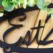 Close up of established year on our custom oval metal sign, in matte black powder coat.