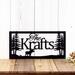 Rectangular personalized family name sign with moose and pine trees, in matte black powder coat.