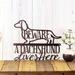 A Dachshund Lives Here metal wall art, with Beware, in copper vein powder coat.