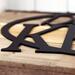 Close up of matte black powder coat on our oval personalized family name sign.