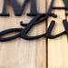 Close up of matte black powder coat on our Bullmastiffs Live Here metal sign.