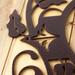 Close up of copper vein powder coat on our metal monogram plaque.