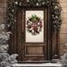 Merry Christmas wreath with plaid ornament, red berries, and white ribbons hanging on a brown wooden door, framed by winter greenery.