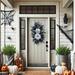 Elegant wreath with disco pumpkins on a rustic front door. Boho-style wreath with gold and black foliage, adding chic decor to your home.