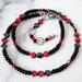 Black and red choker necklace with little hearts.