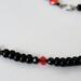 Black glass, spinel and red crystal beads.
