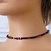 Skinny red heart choker on a mannequin.