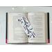 laminated bookmark on top of an open book