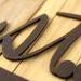 Close up of copper vein powder coat on our oval established year metal wall art.