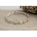 Set of three sterling silver stacking wavy bangle bracelets.